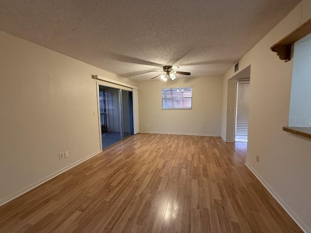 unfurnished room featuring ceiling fan, a textured ceiling, and light wood-type flooring