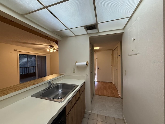 kitchen featuring ceiling fan, light tile patterned floors, and sink