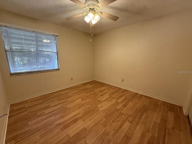 spare room featuring ceiling fan, a textured ceiling, and light hardwood / wood-style flooring