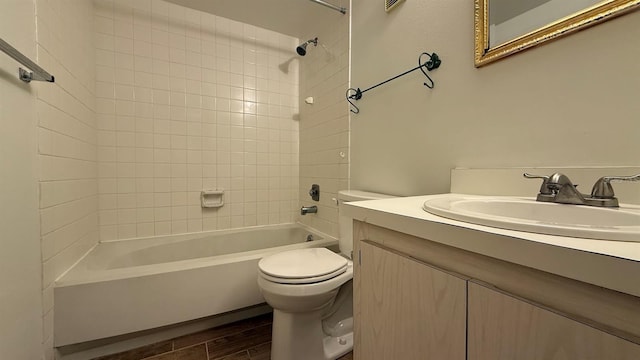 full bathroom with vanity, tiled shower / bath combo, hardwood / wood-style flooring, and toilet