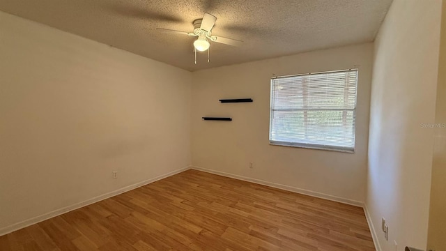 unfurnished room with a textured ceiling, light hardwood / wood-style floors, and ceiling fan