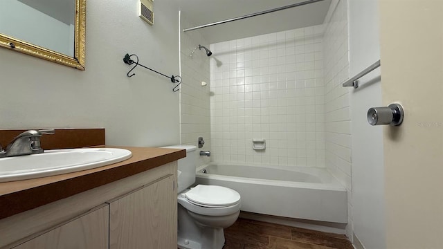 full bathroom with vanity, toilet, and tiled shower / bath combo