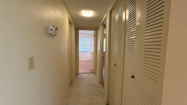 hallway featuring a textured ceiling