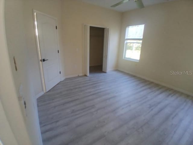 unfurnished bedroom featuring ceiling fan and light wood-type flooring