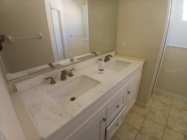 bathroom with tile patterned floors and vanity