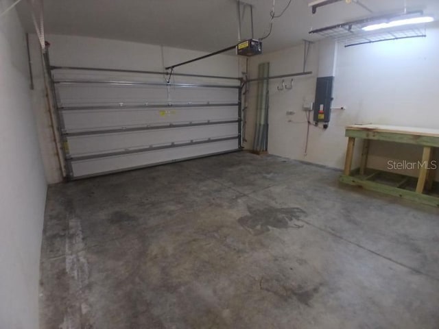 garage featuring electric panel and a garage door opener