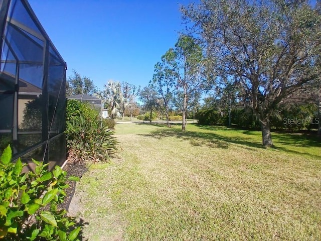 view of yard with a lanai