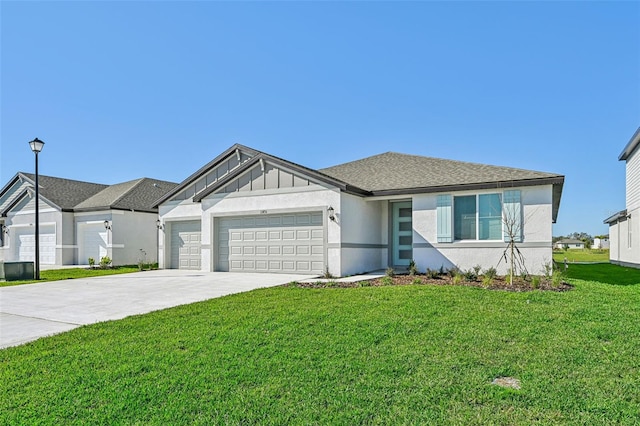 view of front of home with a front lawn and a garage