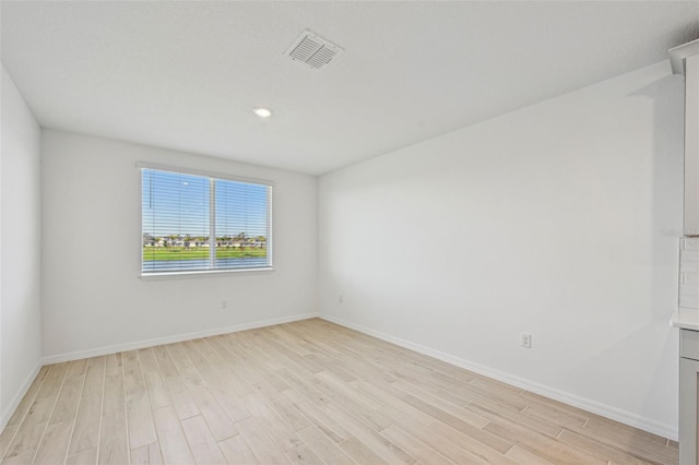 unfurnished room with light hardwood / wood-style floors