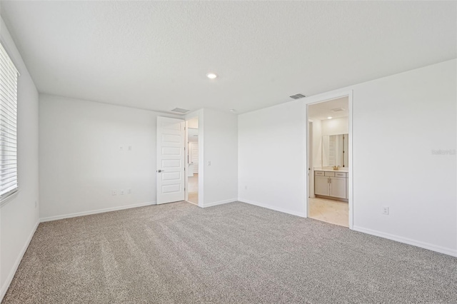 unfurnished room with light carpet