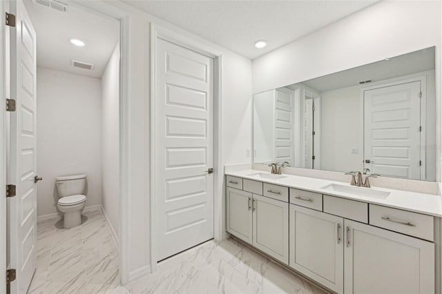 bathroom featuring toilet and vanity