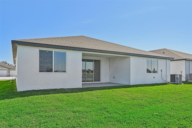 back of house with cooling unit, a yard, and a patio