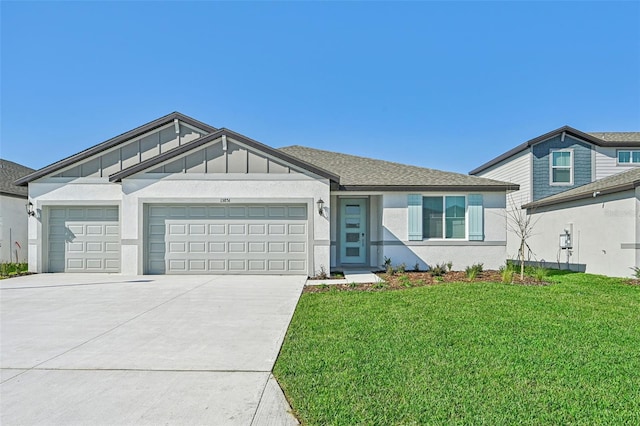 view of front of house featuring a garage and a front lawn