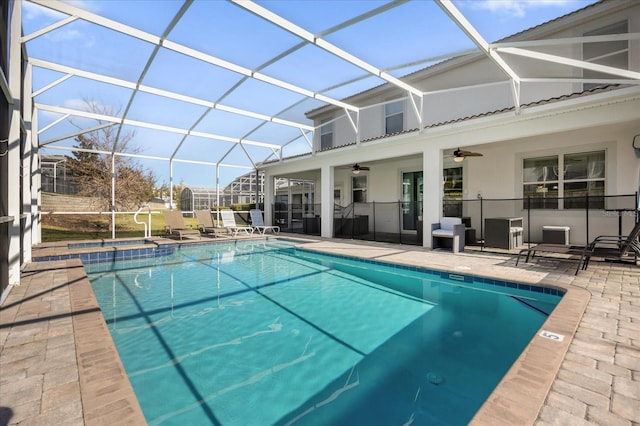 view of pool featuring ceiling fan, a patio area, and a lanai