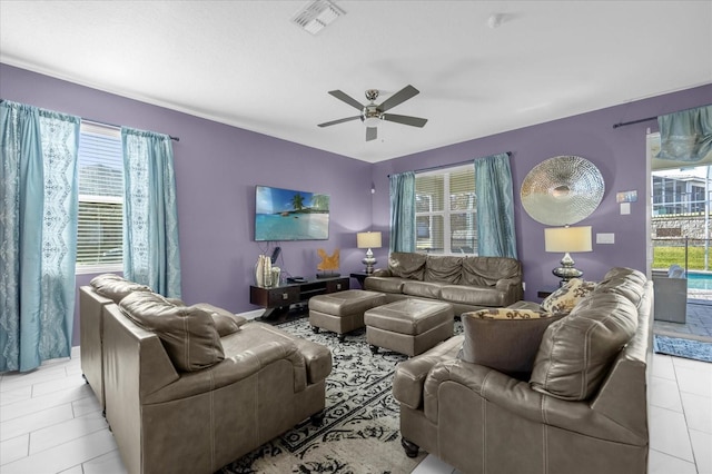 tiled living room featuring ceiling fan and a healthy amount of sunlight