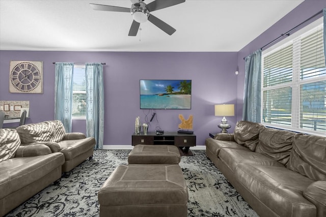 living room featuring light carpet, ceiling fan, and a healthy amount of sunlight