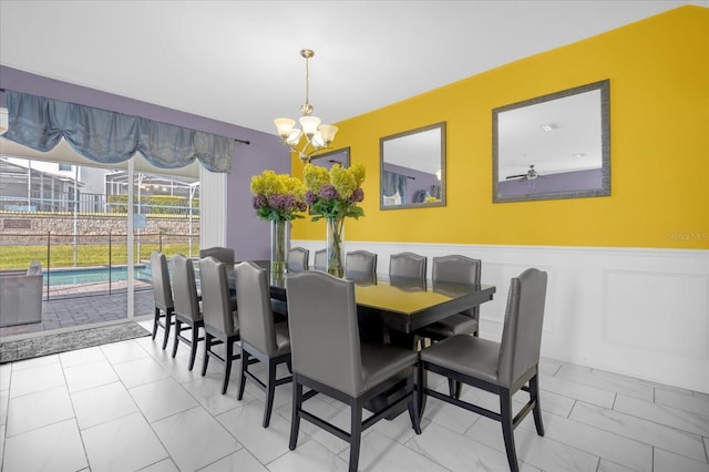 dining room with ceiling fan with notable chandelier