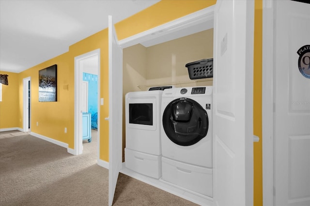 laundry room featuring carpet floors and separate washer and dryer