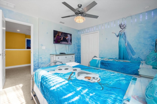 carpeted bedroom featuring ceiling fan and a closet