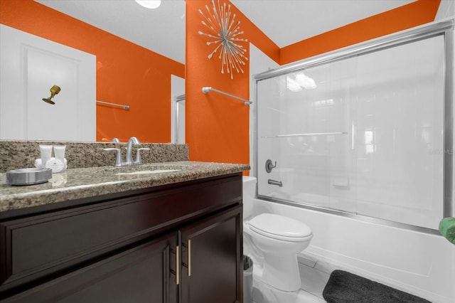 full bathroom featuring tile patterned flooring, vanity, toilet, and enclosed tub / shower combo