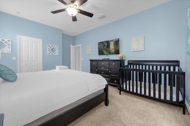 carpeted bedroom with a closet and ceiling fan