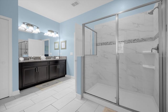 bathroom featuring a shower with door, vanity, and tile patterned flooring