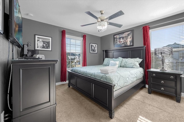 bedroom with light colored carpet and ceiling fan