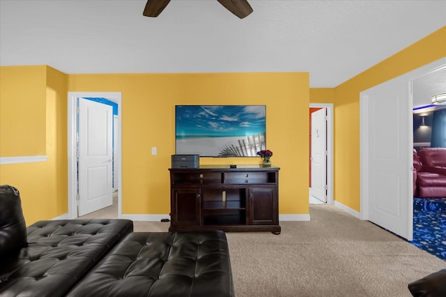 living room with ceiling fan and light colored carpet