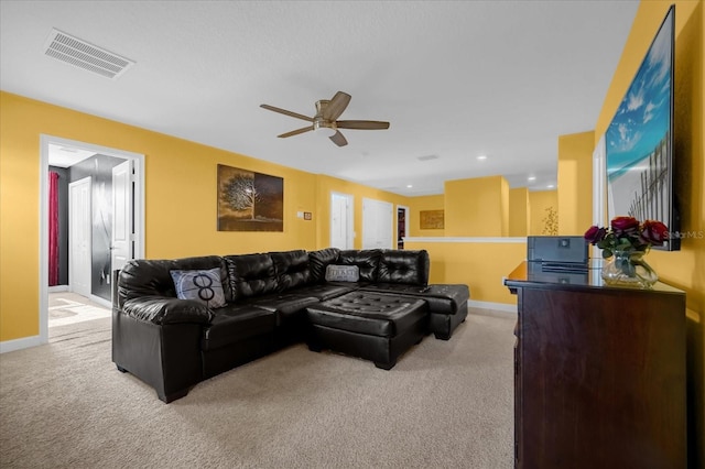 carpeted living room with ceiling fan