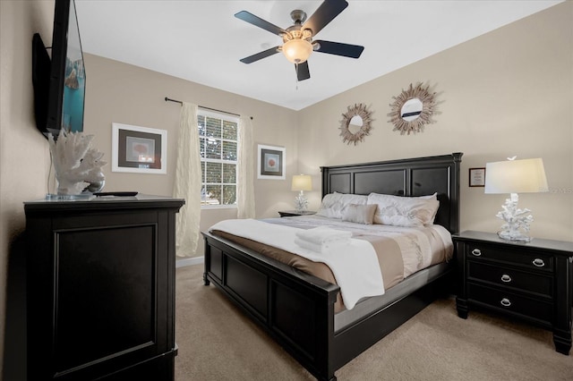 bedroom with ceiling fan and light colored carpet