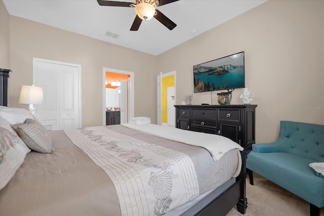 bedroom featuring connected bathroom, ceiling fan, a closet, and carpet floors