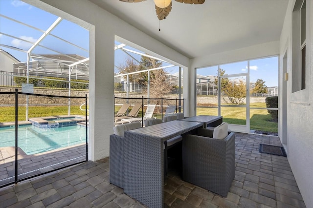 sunroom / solarium featuring ceiling fan