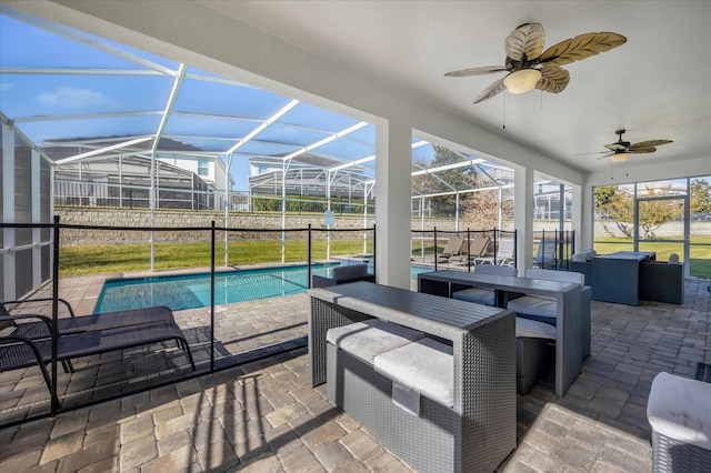 exterior space featuring an outdoor living space, glass enclosure, ceiling fan, and a patio area