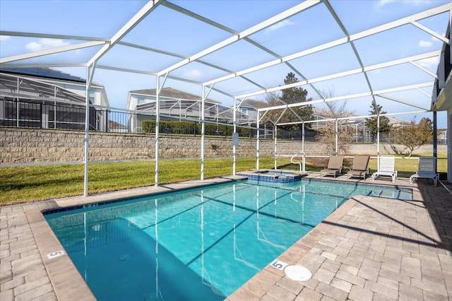 view of pool featuring a yard, glass enclosure, and a patio area