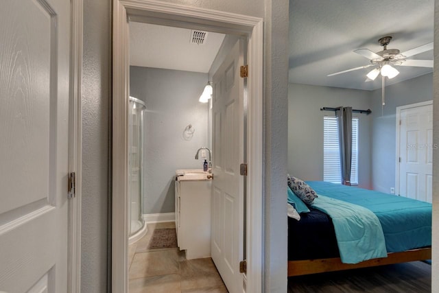 bedroom featuring tile patterned floors, ceiling fan, and sink