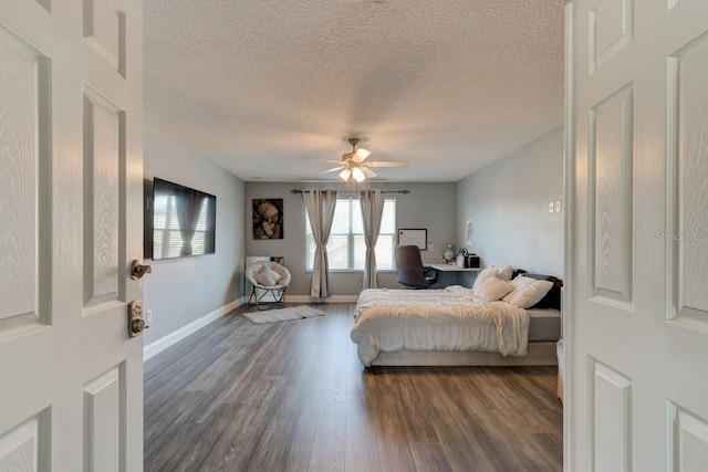 bedroom featuring a textured ceiling, ceiling fan, and dark wood-type flooring