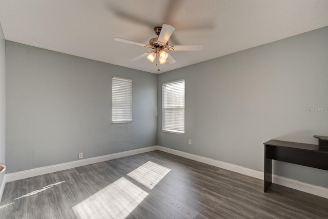 unfurnished room with ceiling fan and dark hardwood / wood-style flooring