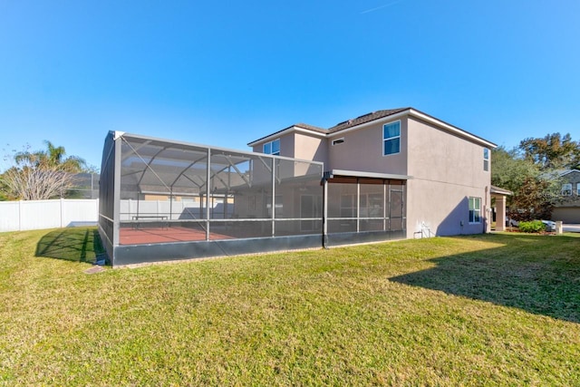 back of property featuring a lawn and a lanai