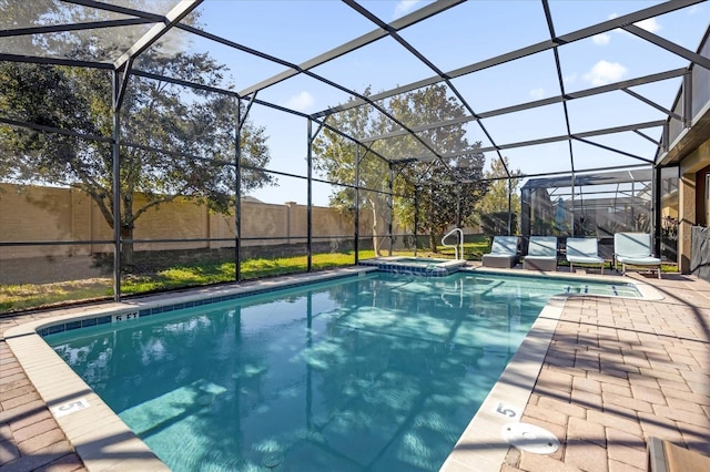 view of pool featuring glass enclosure and a patio area