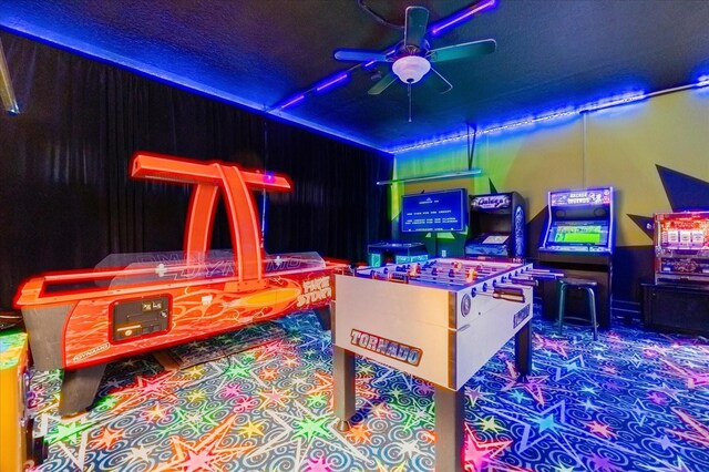 playroom featuring a textured ceiling and ceiling fan