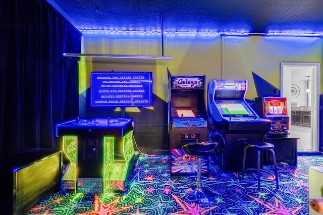 game room with a textured ceiling