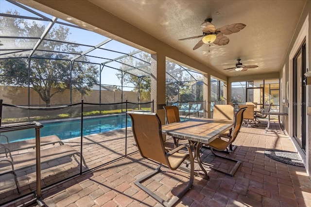 view of swimming pool with a lanai, a patio area, and ceiling fan