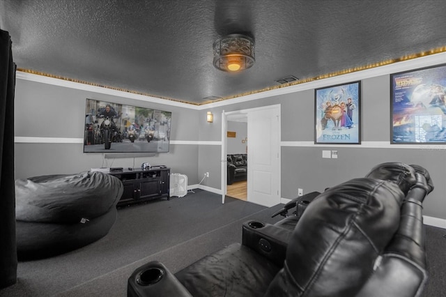 cinema room featuring carpet floors and a textured ceiling