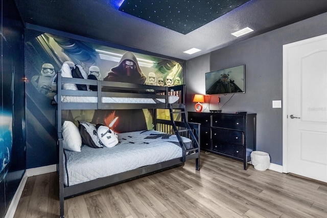 bedroom featuring hardwood / wood-style floors and a textured ceiling