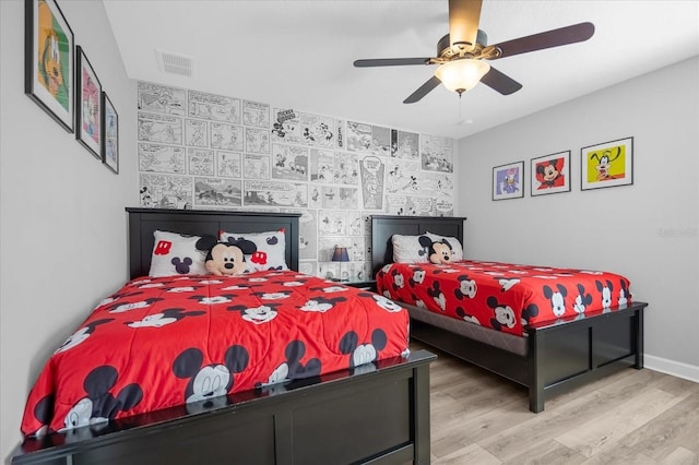 bedroom with light hardwood / wood-style flooring and ceiling fan