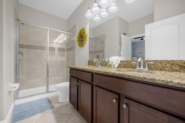 bathroom featuring walk in shower, vanity, ceiling fan with notable chandelier, tile patterned flooring, and toilet