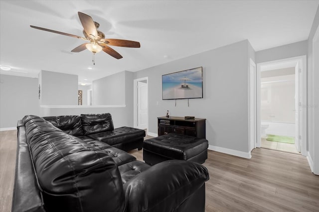 living room featuring light wood-type flooring and ceiling fan