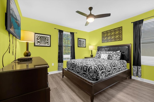 bedroom featuring light wood-type flooring and ceiling fan