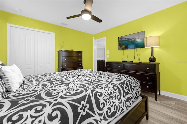 bedroom featuring ceiling fan, a closet, and light hardwood / wood-style floors