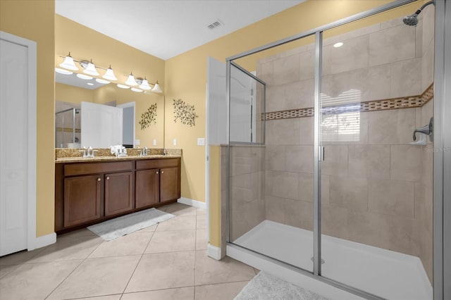 bathroom featuring tile patterned flooring, vanity, and a shower with door